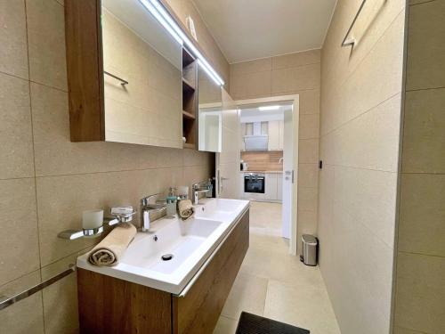 a bathroom with a sink and a mirror at Apartments Bonum in Šilo