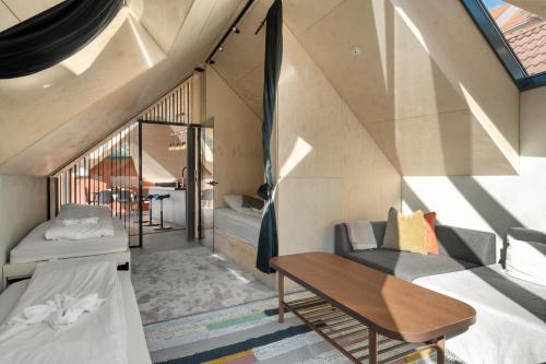 a room with two beds and a table at Bryggen Penthouse I NEW 2021 in Bergen