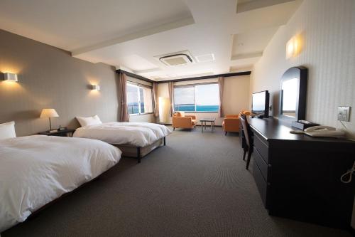 Postel nebo postele na pokoji v ubytování Seaside Hotel Taimaru Kaigetsu