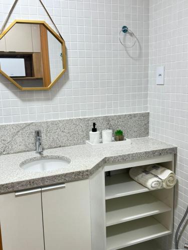 a bathroom with a sink and a mirror at Smart Convenções in Salvador