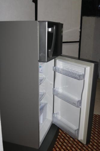 an empty refrigerator with its door open in a room at The Villa Sea Breeze in Talpe