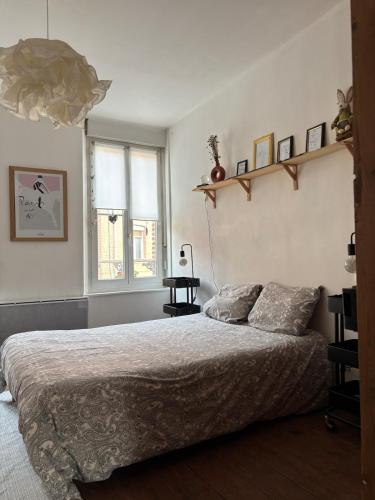 une chambre avec un grand lit et une fenêtre dans l'établissement L Abbeviloise, à Abbeville