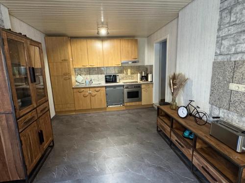 a large kitchen with wooden cabinets and a counter at Gemütlich in Minden in Minden