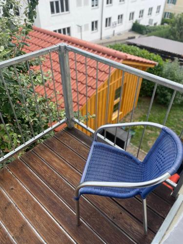 a blue chair sitting on top of a deck at Homestay - Luxus Ferienwohnung in Bad Griesbach