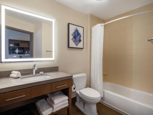 a bathroom with a sink and a toilet and a tub at Candlewood Suites Arundel Mills / BWI Airport by IHG in Hanover