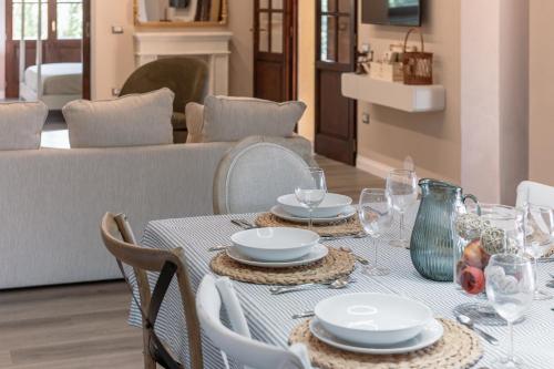 a table with plates and glasses on top of it at Villa Il Poggetto - Tuscany living in Massa Marittima