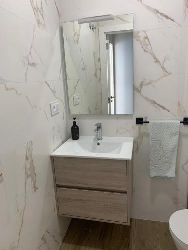 a bathroom with a sink and a mirror at Casa Conricado in O Grove