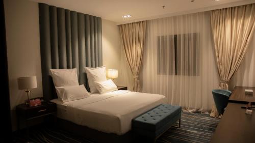 a hotel room with a bed and a chair at فندق سدو بوتيك Hotel SDU BOUTIQUE in Jazan