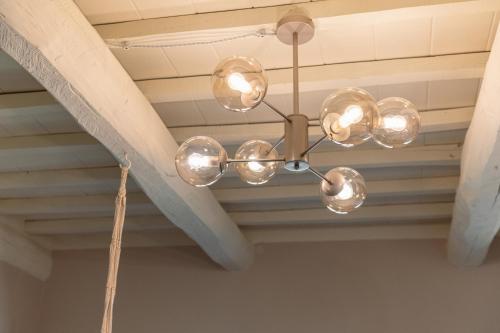 a chandelier hanging from a ceiling in a room at Villa Il Poggetto - Tuscany living in Massa Marittima