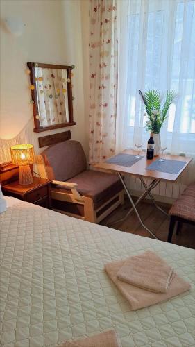 a bedroom with a bed and a table and a couch at Studio Elegance Pamporovo in Pamporovo