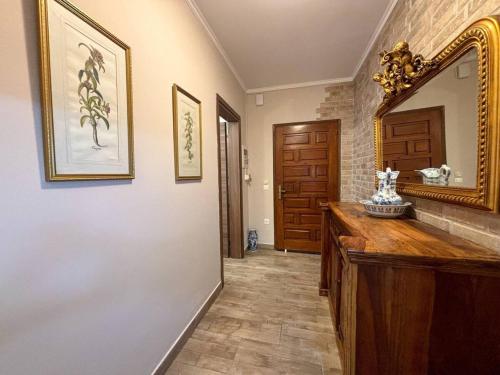 a bathroom with a large mirror and a wooden counter at Dion and Eva's OldTown Apartment in Corfu Town