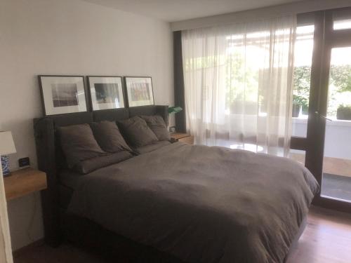 a bedroom with a large bed and a window at Cozy 1 room apartment for 2 in Munich
