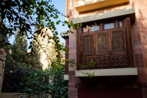 a building with a wooden window on the side of it at Villa Mango Hotel, near the American University in Cairo, AUC, New Cairo in Cairo