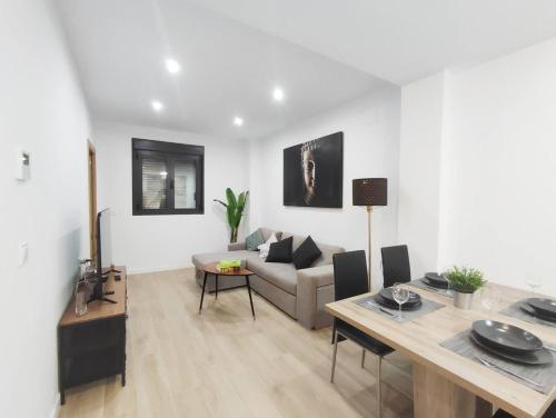 a living room with a couch and a table at Ohana home 1 in Málaga