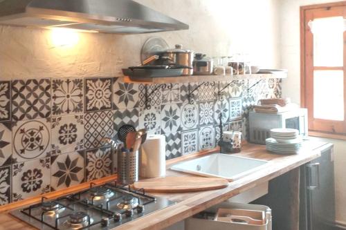 a kitchen with a stove and a counter top at Warm apartment in Ardanué with mountain view, 45 m² in Ardanué