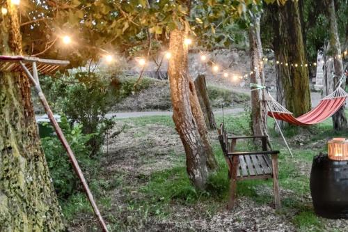 a hammock in a garden under a tree with lights at Warm apartment in Ardanué with mountain view, 45 m² in Ardanué