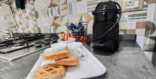 a white tray with two pastries on a kitchen counter at casa di Igor in Ispica