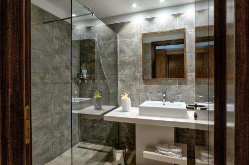 a bathroom with a sink and a shower at La Cigale Tabarka in Tabarka