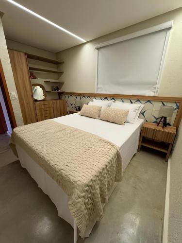 a bedroom with a large bed with a large window at Seaesta Milagres in São Miguel dos Milagres
