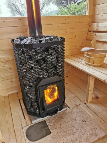 a wood stove in a room in a log cabin at L'Atelier de Maison VB in Le Beausset