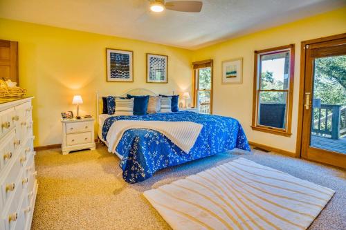 a bedroom with a blue bed and yellow walls at Waterfront luxury w-beach resort-pool-golf-tennis-fishing & views! in Nags Head