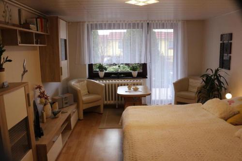 a bedroom with a bed and a table and a window at Inselurlaub in Bergen auf Rügen