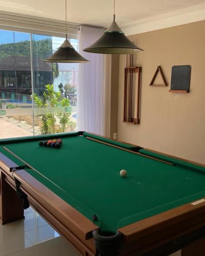 a pool table in a living room with afits at Reserva Praia Hotel in Balneário Camboriú