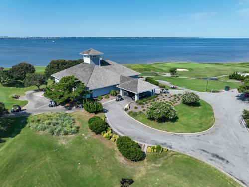 an aerial view of a house with the ocean in the background at Waterfront luxury w-beach resort-pool-golf-tennis-fishing & views! in Nags Head