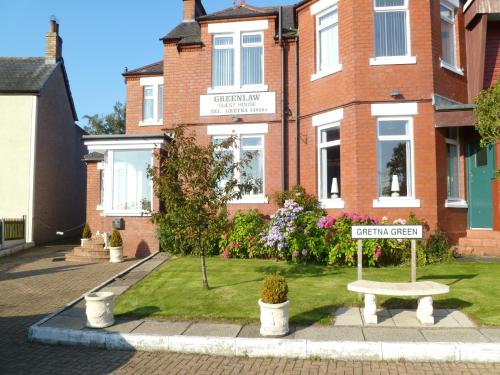 a street sign in front of a brick building at Greenlaw Guest House in Gretna Green