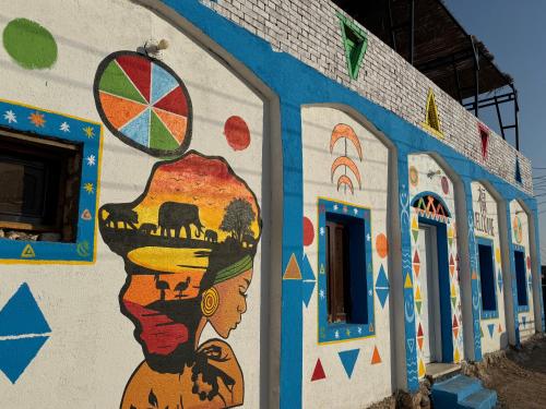 a wall with a painting of a woman on it at king kassem nubian guest house in Aswan