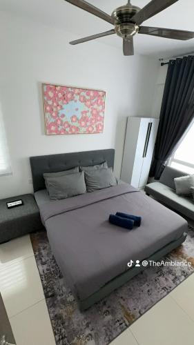 a bedroom with a large bed and a couch at The Ambiance, Melaka in Melaka
