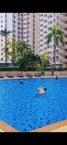 a group of people swimming in a large swimming pool at River View Active 7 in Bangkok