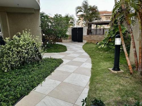 a walkway in front of a house with a parking meter at Bohemian Townhouse Palm Beach Aruba in Palm-Eagle Beach