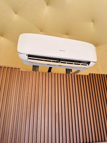 a white air conditioner sitting on top of a wall at Rum Goldeneye luxury camp in Wadi Rum