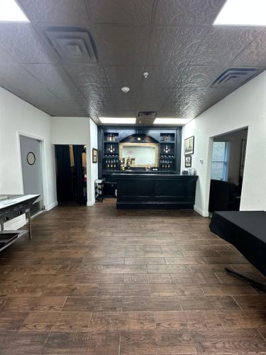 a large room with a bar with a mirror at The Alcalde Hotel in Gonzales