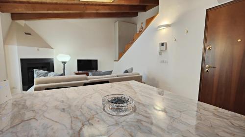 a living room with a marble table and a couch at Giardino Giusti House & Court in Verona