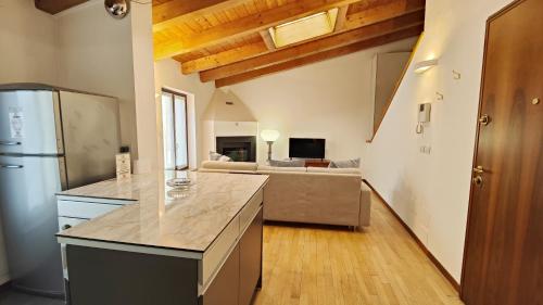 a kitchen with a refrigerator and a living room at Giardino Giusti House & Court in Verona