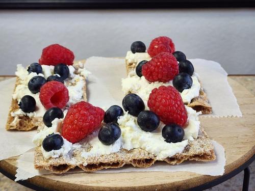 two slices of bread with whipped cream and berries on it at The Alcalde Hotel in Gonzales