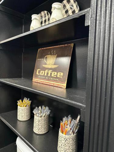 a shelf with a coffee box and some pencils at The Alcalde Hotel in Gonzales