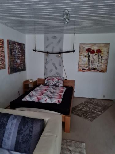 a living room with a bed and a couch at Fels und Seen Land in Ludwigswinkel