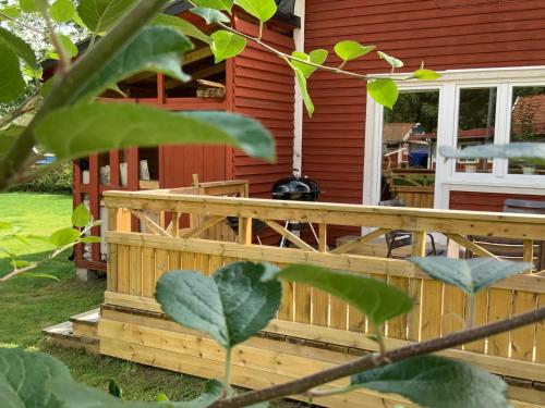 a wooden deck on a house with a porch at Lyckedal in Törnamåla