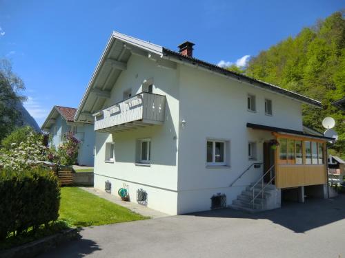 a white house with a balcony on the side at Haus Can in Dalaas