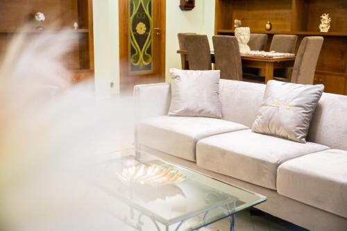 a living room with a couch and a glass table at Villa Asia in Selva di Fasano