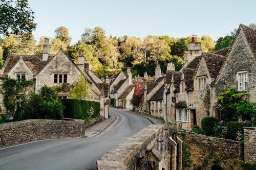 a street in a village with stone houses at The Manor House Hotel and Golf Club in Castle Combe