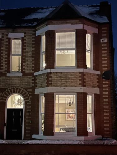 a large brick building with white windows on the front at My Big House Up North Grappenhall Warrington in Warrington
