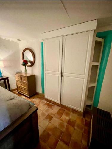 a bedroom with a bed and a dresser with a mirror at 1722 Historic Adobe in El Prado