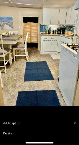 a kitchen with blue rugs on the floor at 1722 Historic Adobe in El Prado