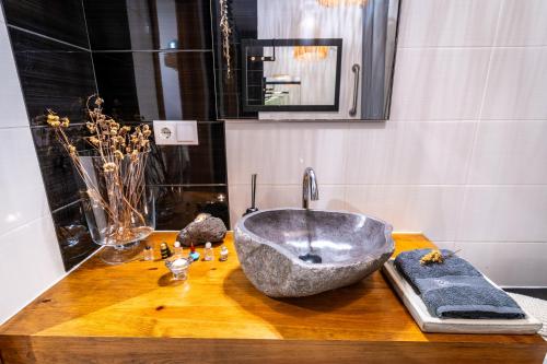a bathroom with a large sink on a wooden counter at epicenter CITY in Ponta Delgada