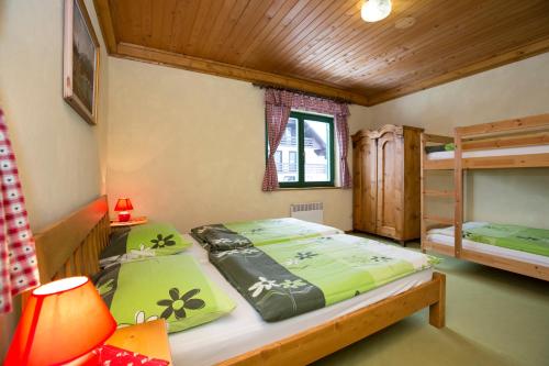 a bedroom with two bunk beds and a lamp at Cottage Suha in Bohinj