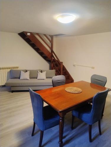 a dining room table with chairs and a couch at Cà d'Elsa in Pieve Vergonte